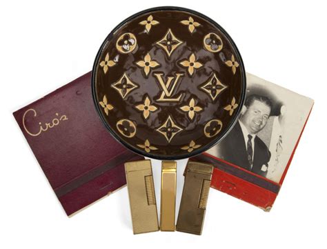 ROSE MARIE LOUIS VUITTON ASHTRAY AND LIGHTERS.